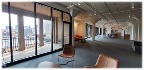 A room with chairs and a glass door

Description automatically generated